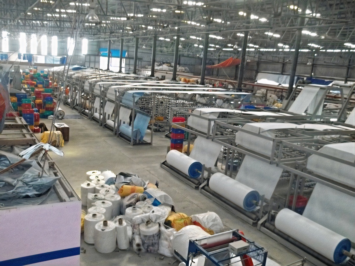 Looms and fabric rolls on the SMVD factory floor