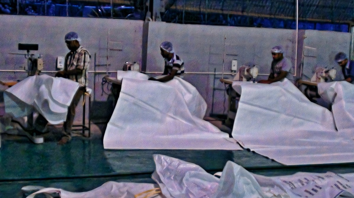 Workers finishing jumbo bag fabric